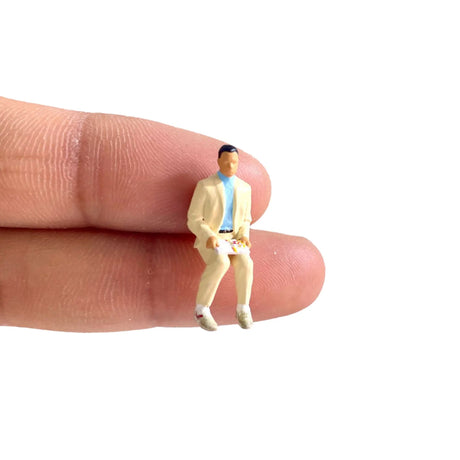 Macro close-up of 1/64 scale hand-painted resin movie character figure sitting pose
